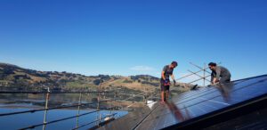Infinite Energy install team on roof installing panels in Queenstown