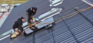 Infinite Energy Team installing panels on roof